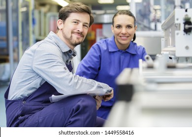 cheerful woman and man industrial engineer at work - Powered by Shutterstock