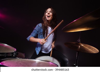 Cheerful Woman Playing The Drums