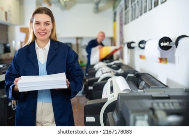 Cheerful Woman Printing Shop Manager Holding Ream Of Paper And Looking At Camera.