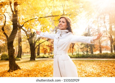 Cheerful woman relaxing in beautiful autumn day, concept Ã?Â¢?? freedom