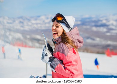 Cheerful Woman Snowboarder Laughs In Winter Mountains