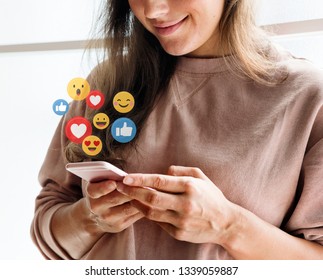 Cheerful woman watching a video live streaming on her phone