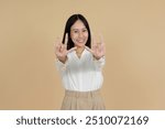 A cheerful woman in a white blouse making the 