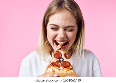 Cheerful woman white t-shirt pizza fast food diet snacking pink background