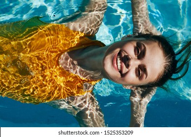 Cheerful Woman In Yellow Swimsuit At Luxury Charm Pool