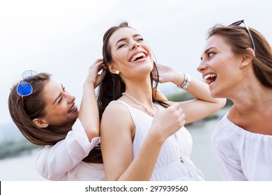 Cheerful women having fun outdoors and laughing happily