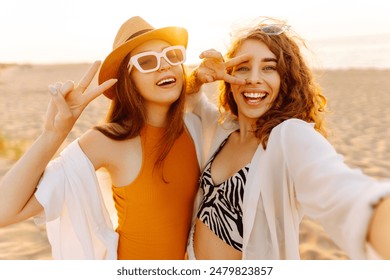 Cheerful women making selfie while having fun on the beach. Friends together. Travel, blogging, weekend, relax and lifestyle concept. - Powered by Shutterstock