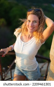 Cheerful Young 30s Caucasian Woman Posing On Tower Stairs In Nature