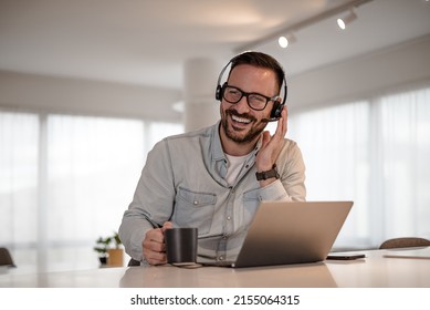 Cheerful Young Adult Businessman Entrepreneur Freelancer Making Online Video Call. Portrait Of Man Working From Home Office Providing Call Support Call Center Operator.