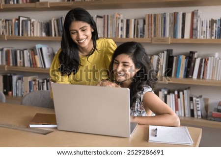 Similar – Image, Stock Photo two student girls sitting on the stairs watching the mobile