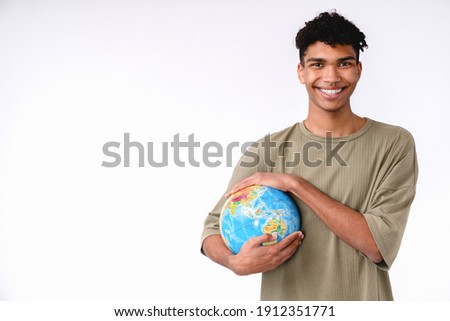 Cheerful young african man holding a globe to save the planet isolated over white background