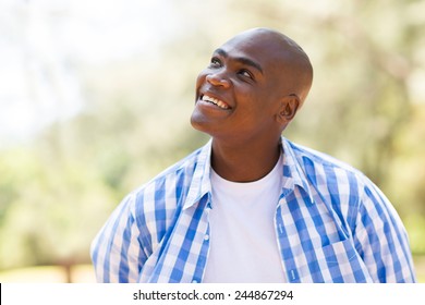 Cheerful Young African Man Looking Up