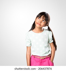 Cheerful Young Asian Girl Posing With Looking Up, Studio Shot