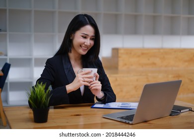 Cheerful Young Asian Woman Using Laptop Computer At Home. Student Female In Living Room. Online Learning, Studying , Online Shopping, Freelance, Asean Concept