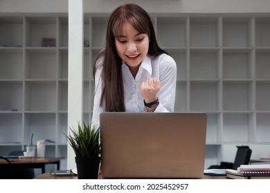 Cheerful Young Asian Woman Using Laptop Computer At Home. Student Female In Living Room. Online Learning, Studying , Online Shopping, Freelance, Asean Concept