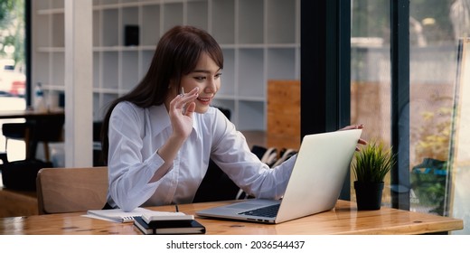 Cheerful Young Asian Woman Using Laptop Computer At Home. Student Female In Living Room. Online Learning, Studying , Online Shopping, Freelance, Asean Concept