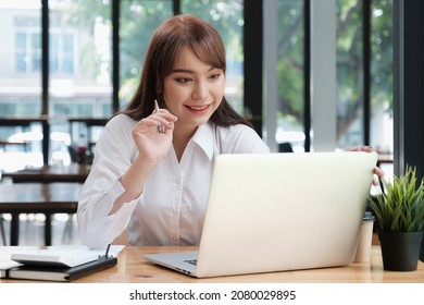 Cheerful Young Asian Woman Using Laptop Computer At Home. Student Female In Living Room. Online Learning, Studying , Online Shopping, Freelance, Asean Concept