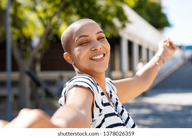 Cheerful Young Bald Woman Spreading Arms Feeling Happy. Smiling Girl Feeling Free With Closed Eyes Outdoor. Happy Curvy Woman Enjoying The Day While On Holiday.
