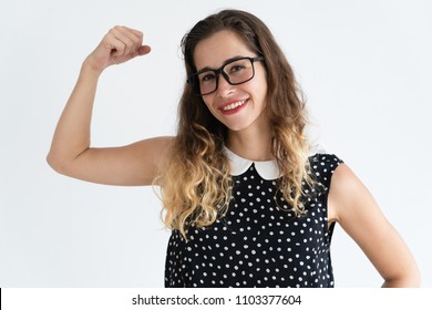 Cheerful young beautiful woman pumping fist, celebrating achievement and looking at camera. Success concept. Isolated front view on white background.