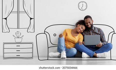 Cheerful young black couple look at laptop  sitting floor in empty room and drawings white wall background  Relocation  buy furniture for house planning interior design using pc  panorama