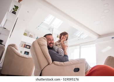 Cheerful young boy having fun with father on sofa - Shutterstock ID 519095176