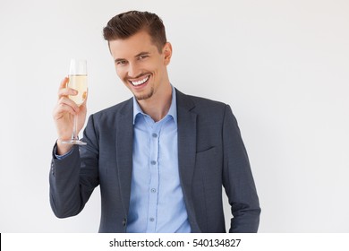 Cheerful Young Business Man Raising Glass Of Wine