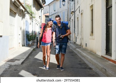 Cheerful Young Couple Backpacker Traveling And Sightseeing In Europe During Summer