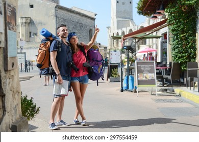 Cheerful Young Couple Backpacker Traveling And Sightseeing In Europe During Summer