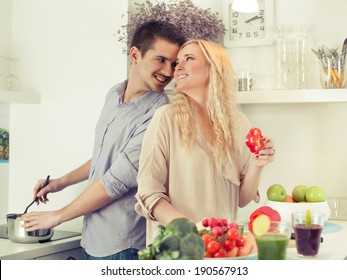 Cheerful Young Couple Cooking Together.