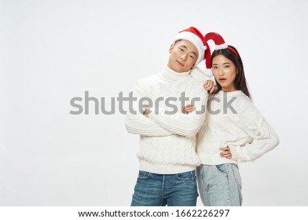 Cheerful young couple gift holiday christmas fun