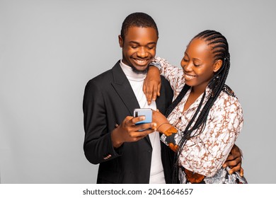 Cheerful Young Couple Looking At Smartphone