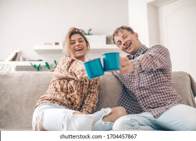 Cheerful young couple in the morning at home. Cheerful young couple enjoying coffee. Good morning. Happy day. Sensual. Love concept. Home concept. Holidays. Happiness. 
