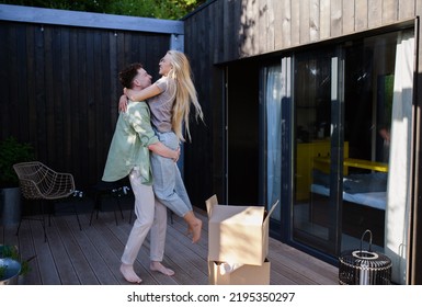 Cheerful Young Couple Moving In Their New Tiny House In Woods. Conception Of Moving And Sustainable Living.