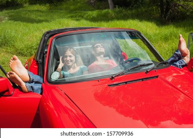 Cheerful Young Couple Relaxing In Classy Cabriolet On A Sunny Day