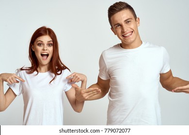 cheerful young couple in white t-shirts on a light background, logo                                - Shutterstock ID 779072077