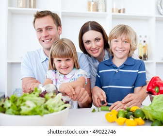 Cheerful Young Family Cooking Together In The Kitchen