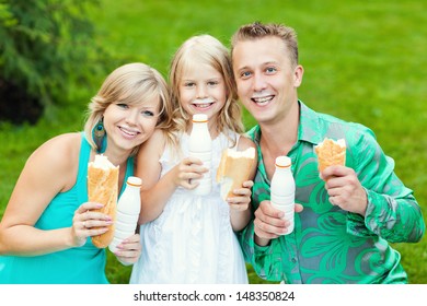 Cheerful Young Family On A Picnic. Milk Mustache