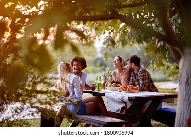 cheerful young friends having  at party outdoor,talking and laughing enjoying at friendship. - Powered by Shutterstock