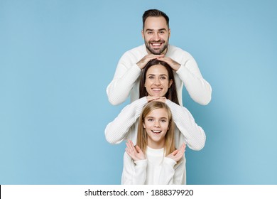 Cheerful Young Happy Parents Mom Dad With Child Kid Daughter Teen Girl In Basic White Sweaters Stand Behind Each Other Isolated On Blue Color Background Studio Portrait. Family Day Parenthood Concept