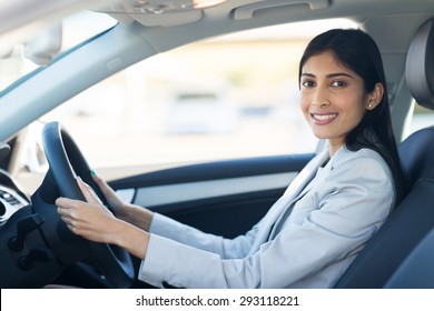 Cheerful Young Indian Businesswoman Driving A Car