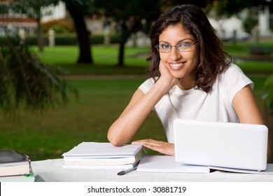 Cheerful Young Indian College Student Outdoors With Laptop