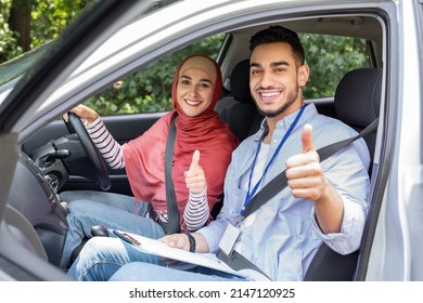 Cheerful Young Islamic And Woman In Hijab At Steering Wheel In Car Show Thumbs Up In Cabin Auto, Outdoor. Student Take Driving Test Good, Driving Class And Lesson In Traffic At City, Great Result