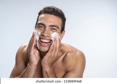 Cheerful Young Male Washing His Face Using Cleansing Foam