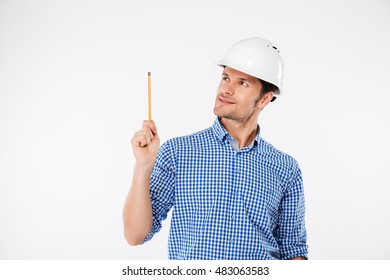 Cheerful Young Man Building Engeneer In Hard Hat Pointing Up With Pencil