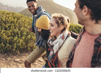 Cheerful Young Man Laughing While Hiking With Friends. Friends Having Fun On Their Hiking Trip.