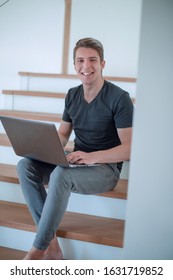 Cheerful Young Man Talking By Video Link Using Laptop