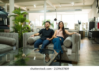 Cheerful Young Man And Woman Smiling While Looking To Buy New Furniture At A Beautiful Showroom