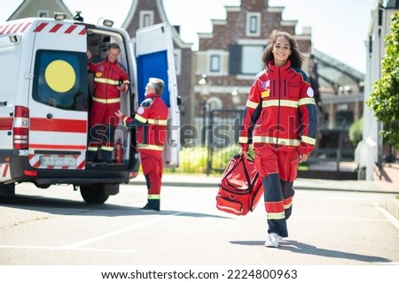 Cheerful young paramedic arriving for her day shift