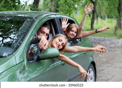 Cheerful Young People Having Summer Trip On A Car.