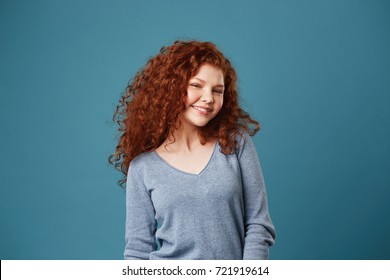 Cheerful Young Student Girl With Wavy Red Hair And Freckles Brightfully Smiling Showing Her Teeth, Posing For Graduation Photo Album.